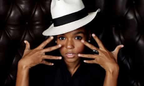 Janelle Monae wearing a white fedora with a black band.