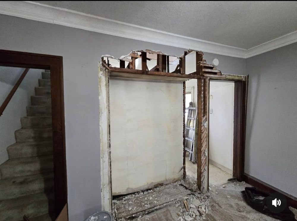 Area where built in buffet and wooden doors to kitchen and second floor once were but now are removed