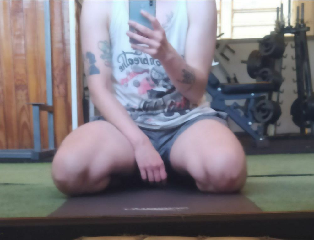 Photo of myself at the gym, sitting on my legs. 