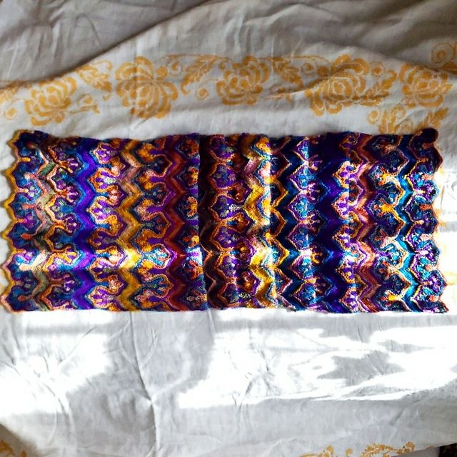 A folded Fow Paws shawl. This pattern uses stacked stitches to create the Paws. 