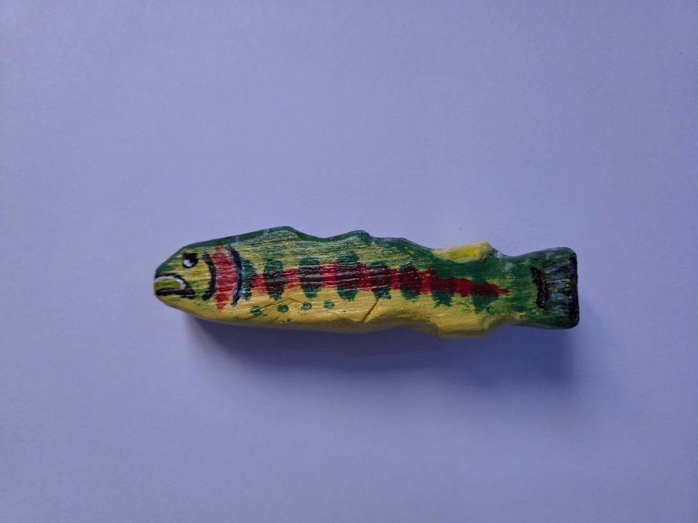 A wooden fish i carved and now painted that goes by the name of whittimer