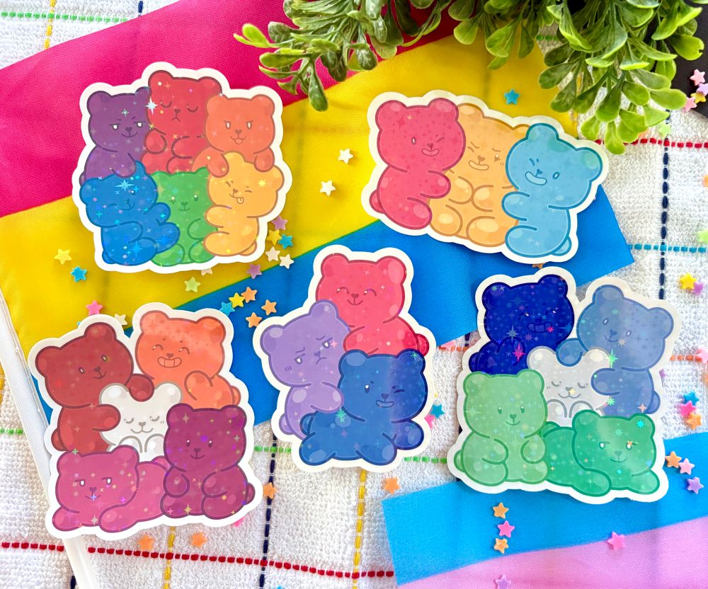 Gummy bear stickers/magnets in the rainbow, pansexual, lesbian, bisexual, and MLM flag colors. 