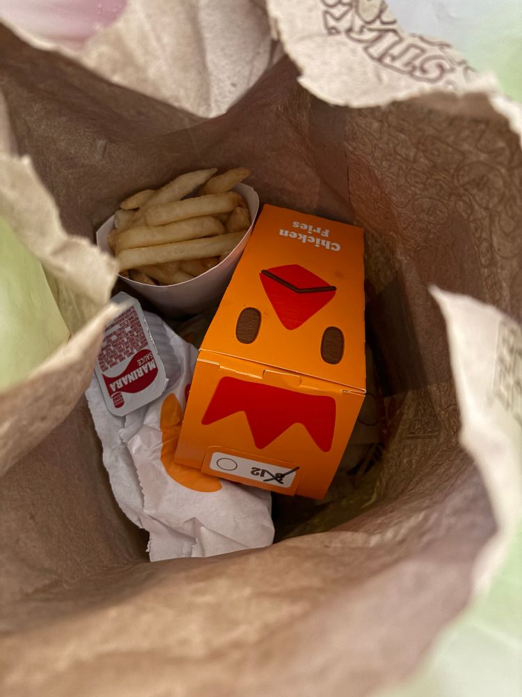 The inside of a Burger King bag with lots of food in it