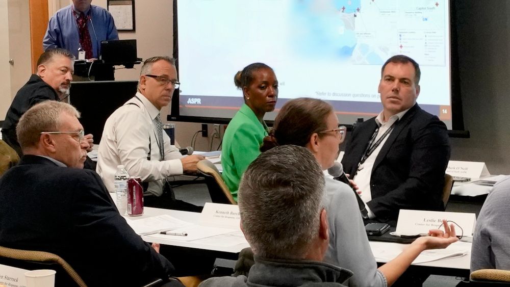 From left to right, photo of Jonathan Greene, John Knox, and Nikki Bratcher-Bowman at the a 2025 table top exercise (TTX). 