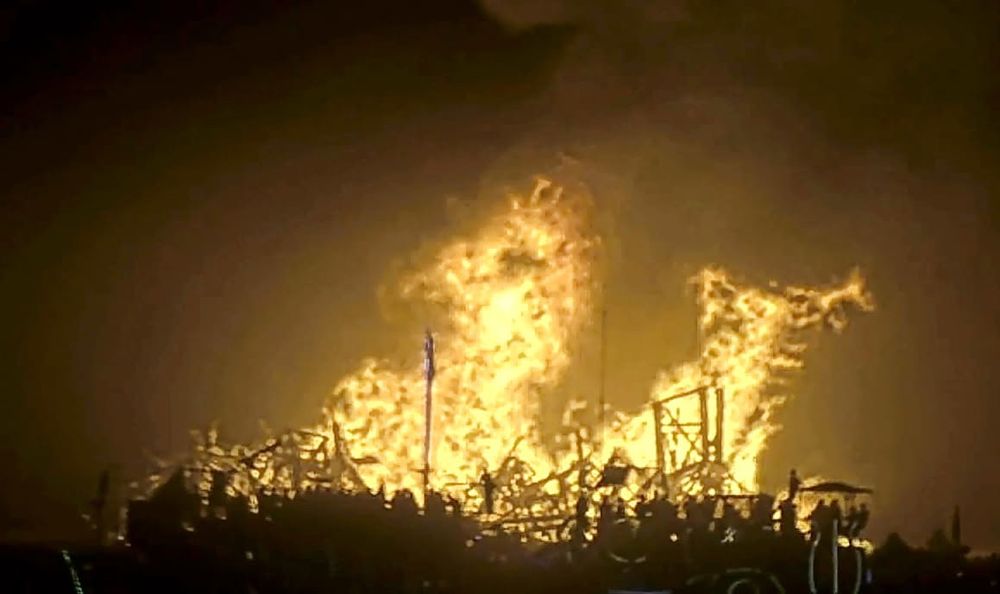 A massive golden fire in front of thousands of Burning Man participants consumes the structure of the temple they built this year. It burned this evening and the event ends tomorrow. 