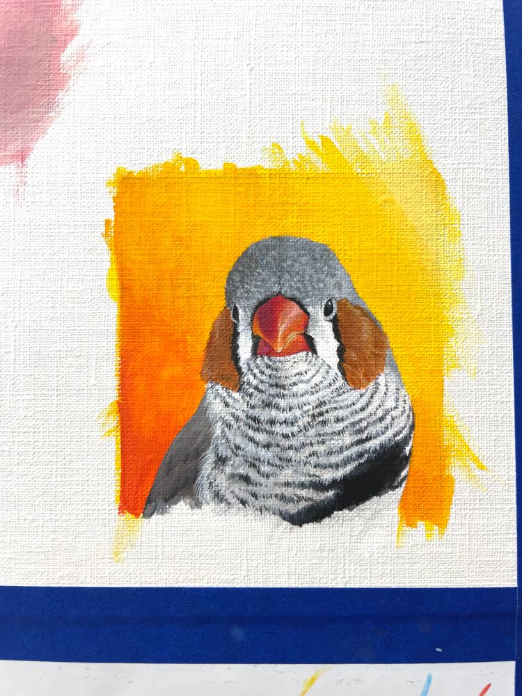 A small acrylic painting of a male zebra finch. 