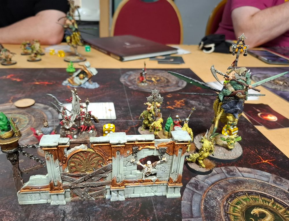 Models fighting near some battlefield terrain