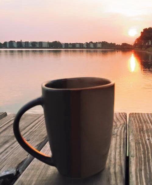 Coffee mug with a lake in the background 