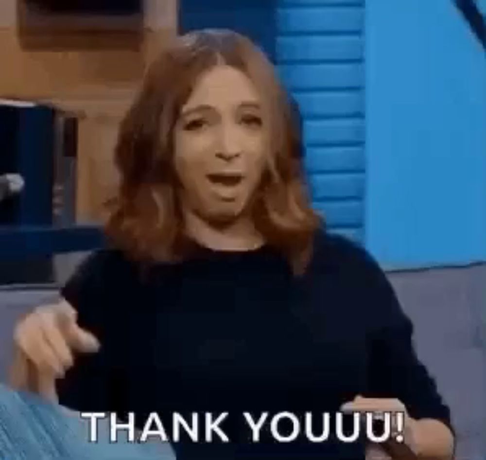 a woman is sitting on a couch giving a thank you speech .