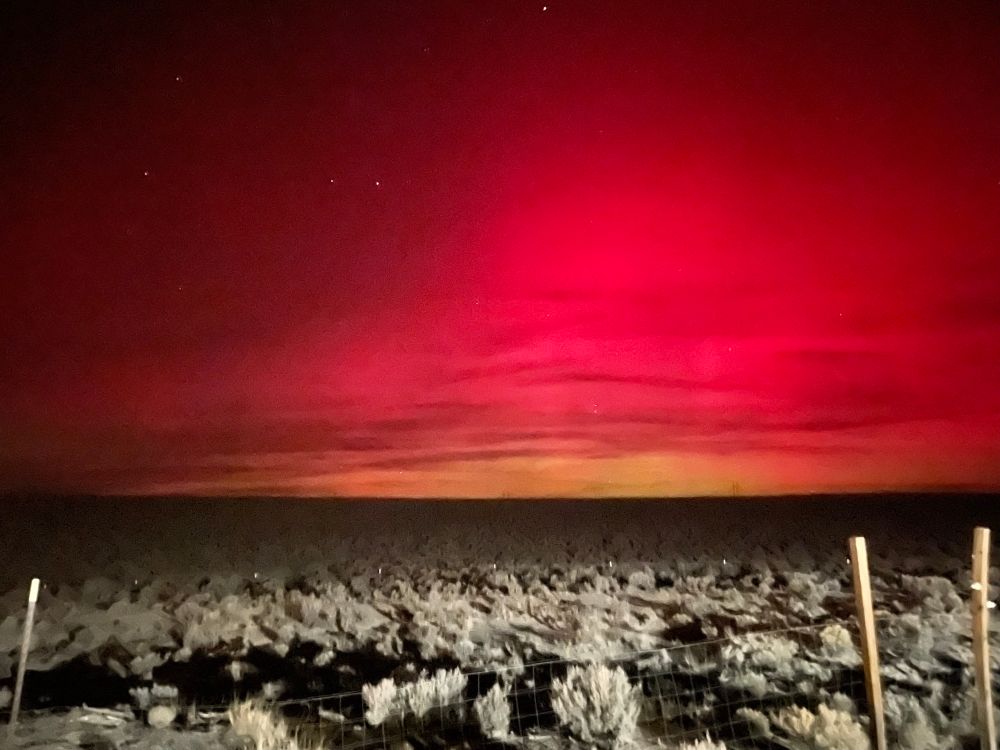 Reddish night sky over the dark desert. 