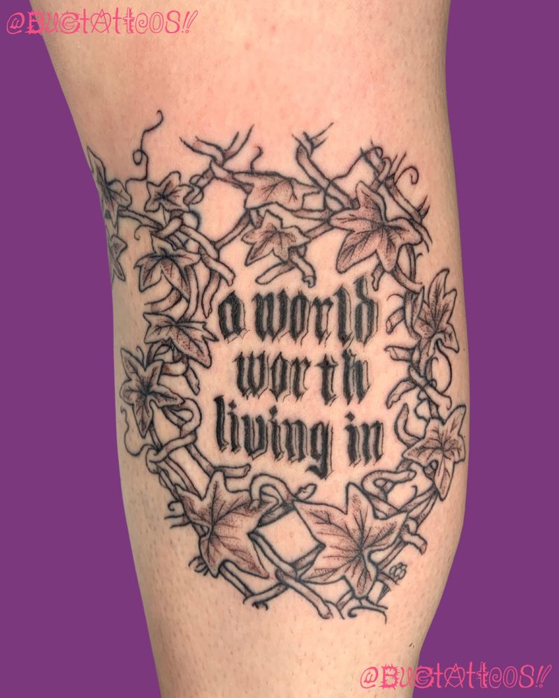 a tattoo on olivias leg of words A WORLD WORTH LIVING IN encased in the empty space of a torn open chain link fence intertwined with ivy she has a light skintone and the tattoo is done in black ink with grey wash shading and it wraps from her inner leg up to under her knee