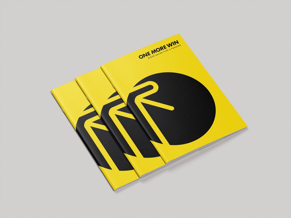 Three copies of One More Win: Ridge Racer Type 4 Fanzine sitting on a white surface.
