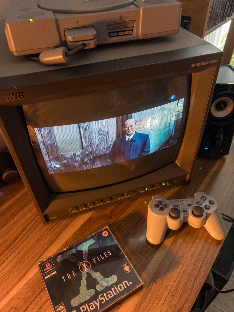 A CRT TV with a PS1 on it running The X-Files Game.