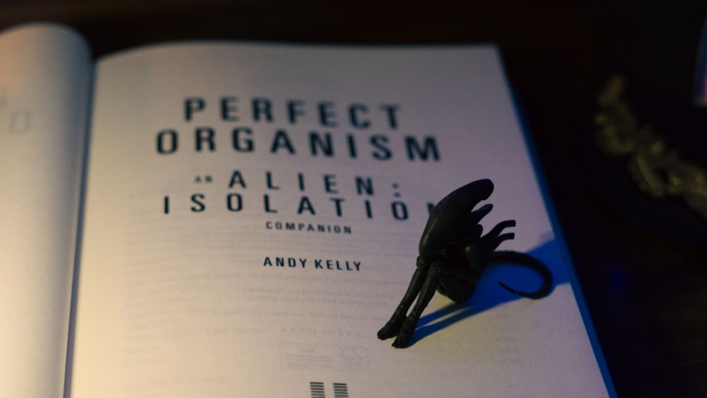 The inside cover of my book with a xenomorph chilling on it.