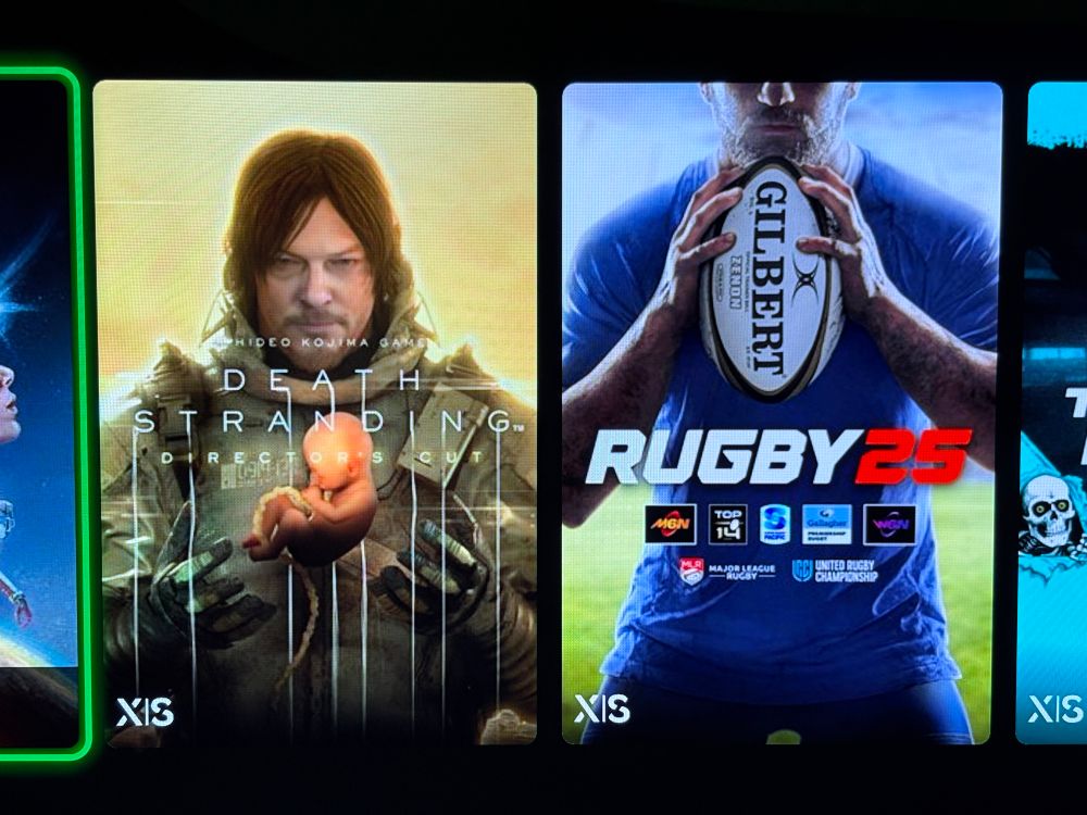 John Death Stranding holding a baby and John Rugby holding a rugby ball in a similar fashion.