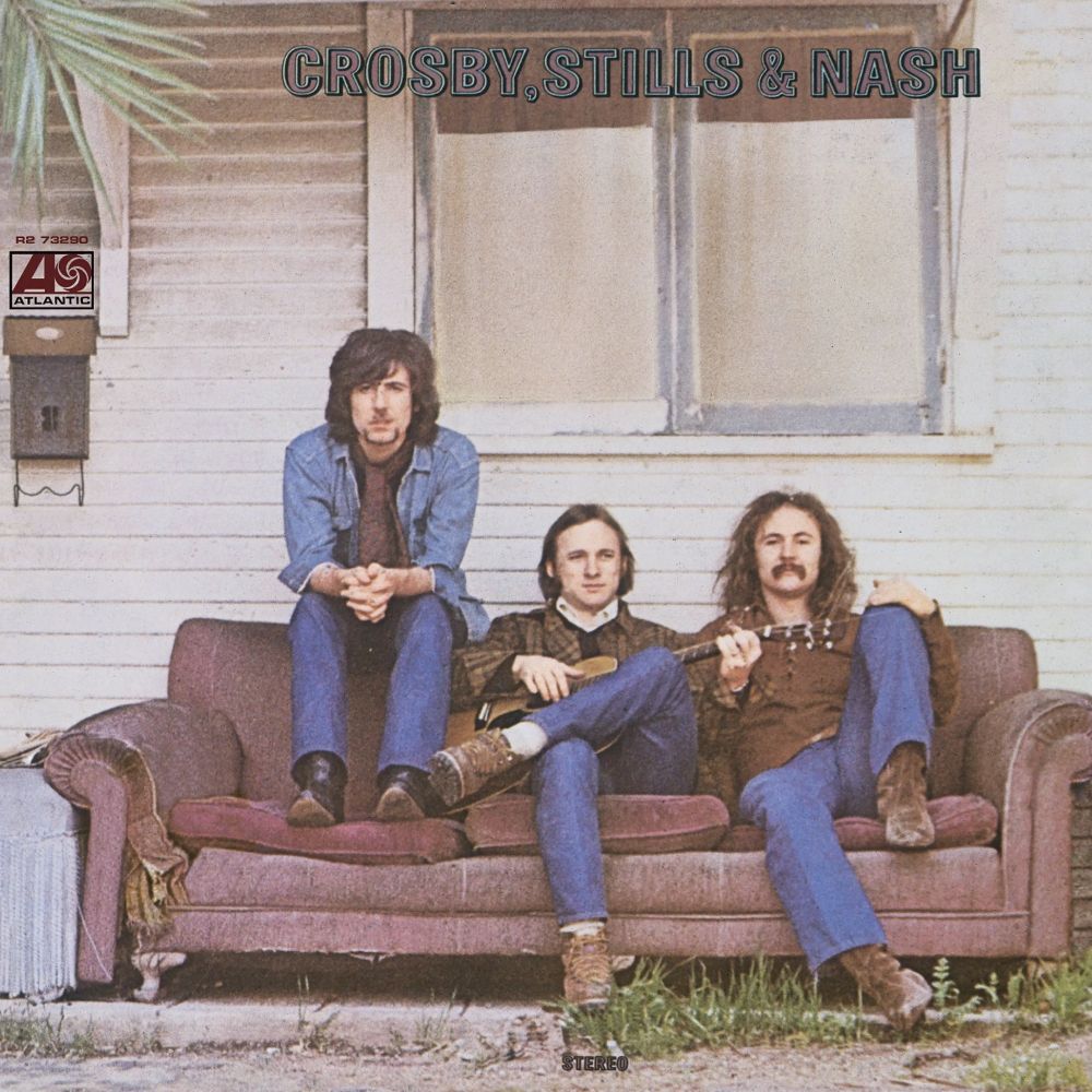 Crosy, Stills and Nash sitting on a couch.