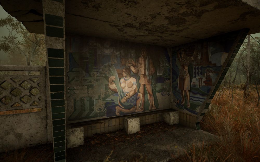 A bus stop in STALKER 2 with an elaborately painted mural.