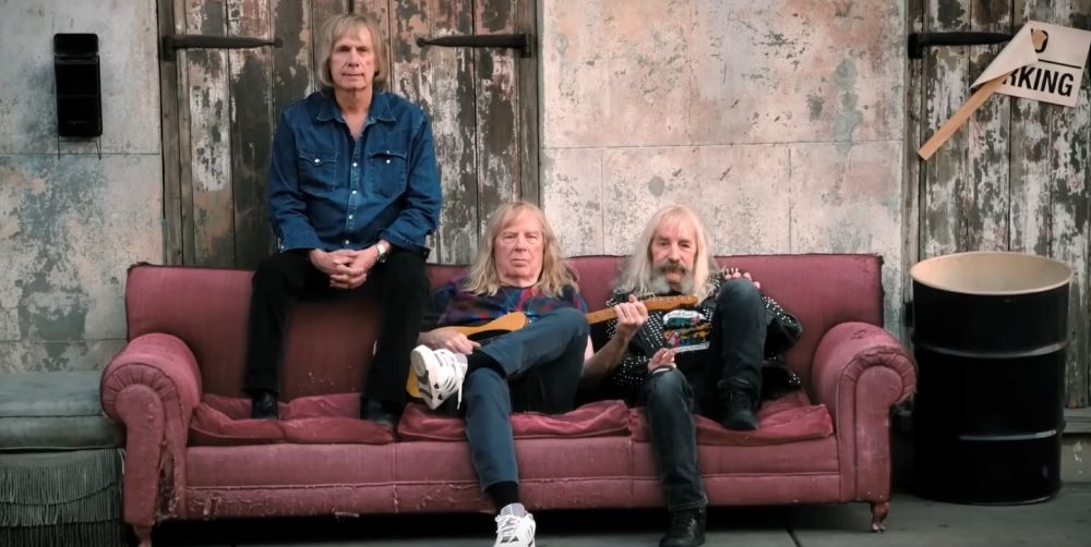 Spinal Tap sitting on a couch.
