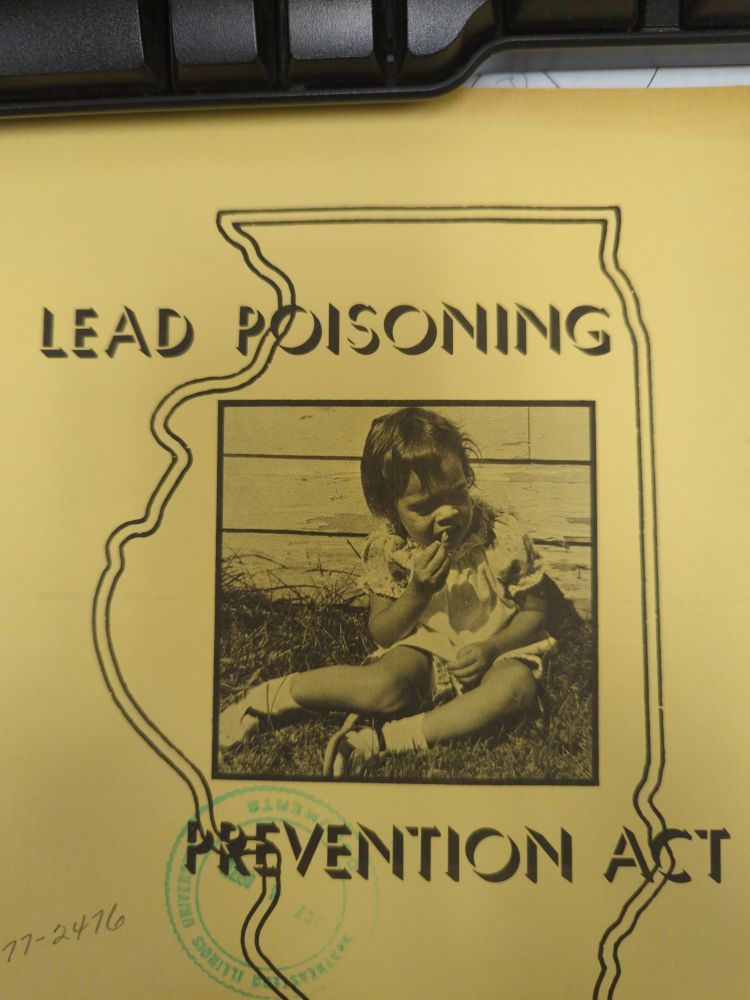 The cover of a book entitled "Lead poisoning prevention act" with a photograph of a small child eating paint chips