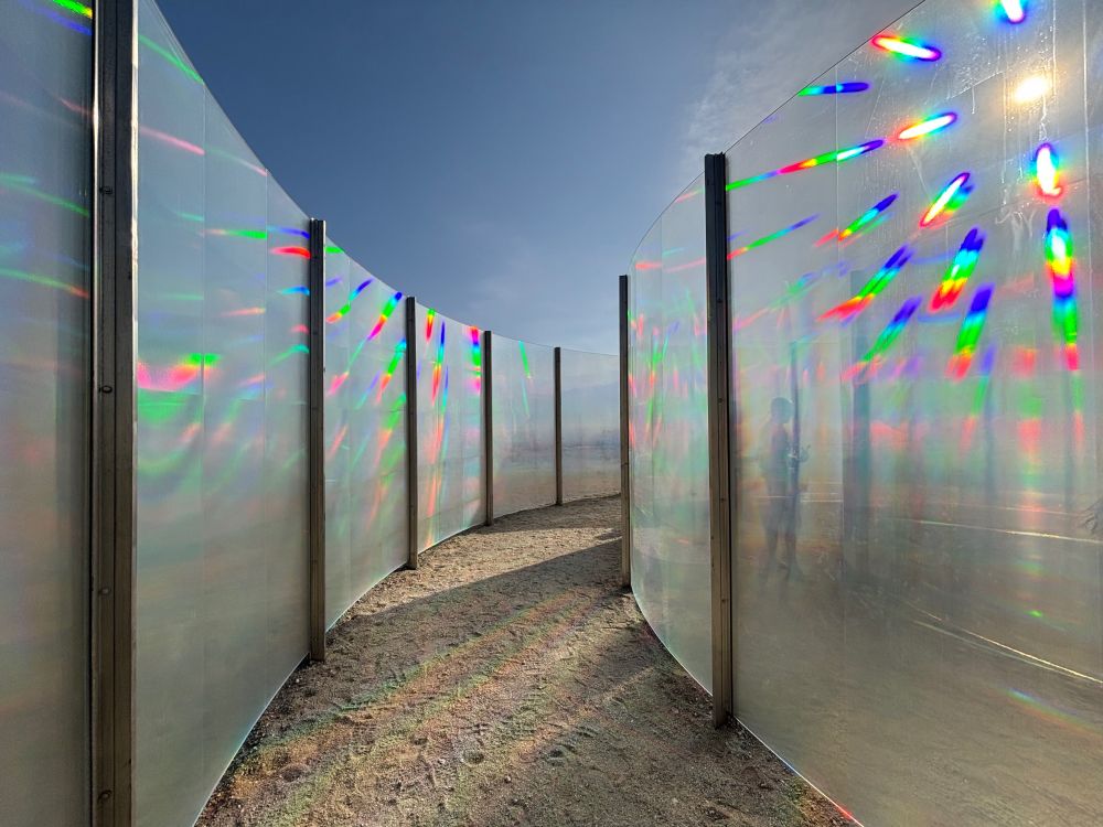 Iridescent architectural glass spiral in the desert.