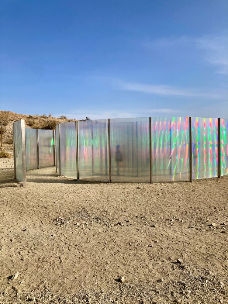 Iridescent architectural glass spiral in the desert.