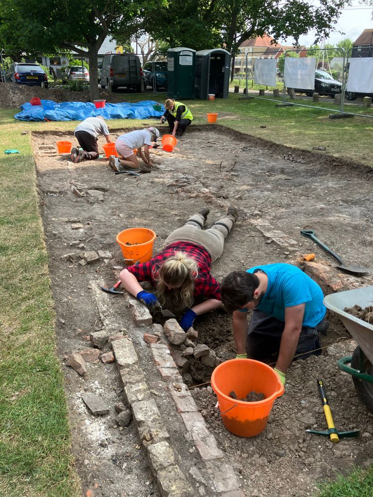 Archaeologists digging the remains of 19th century houses. 