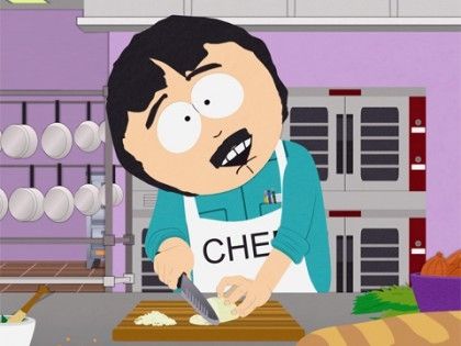 Randy Marsh smiling for the camera while cooking in a professional kitchen for a food show in the South Park episode "Creme Fraiche."