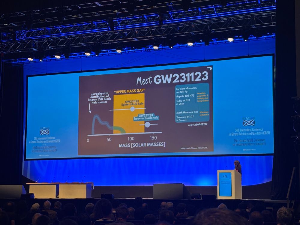 Amanda Farah at a podium in front of a slide introducing GW231123