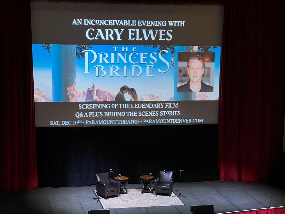 A photo of two empty chairs on the stage at Denver’s Paramount Theater awaiting a screening of The Princess Bride to be followed by Q&A with Cary Elwes. 