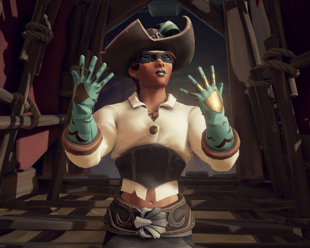 Mel standing outside of her home showing off some fancy blue gloves.