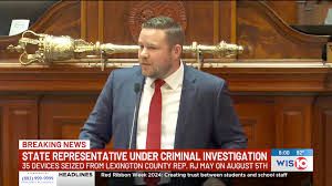 Picture of a South Carolina State Representative RJ May accused of sending over a thousand videos depicting graphic child sexual abuse material. The caption says: Breaking News. State Representative under criminal investigation. 35 devices seized from Lexinton County Rep RJ May on August 5th.