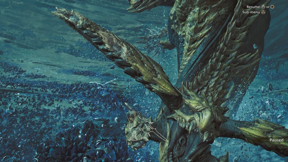 A screenshot from Monster Hunter Wilds. A Rey Dau, or giant lightning wyvern, swoops at the camera with jaws open. Behind it is the tiny silhouette of the player character, dodging out of the way.