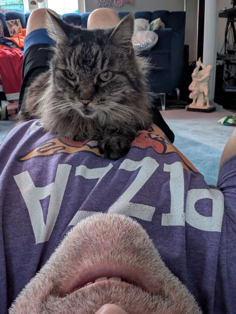 Man laying on the grind with his beautiful kitty laying on top of him. Keeping warm.
