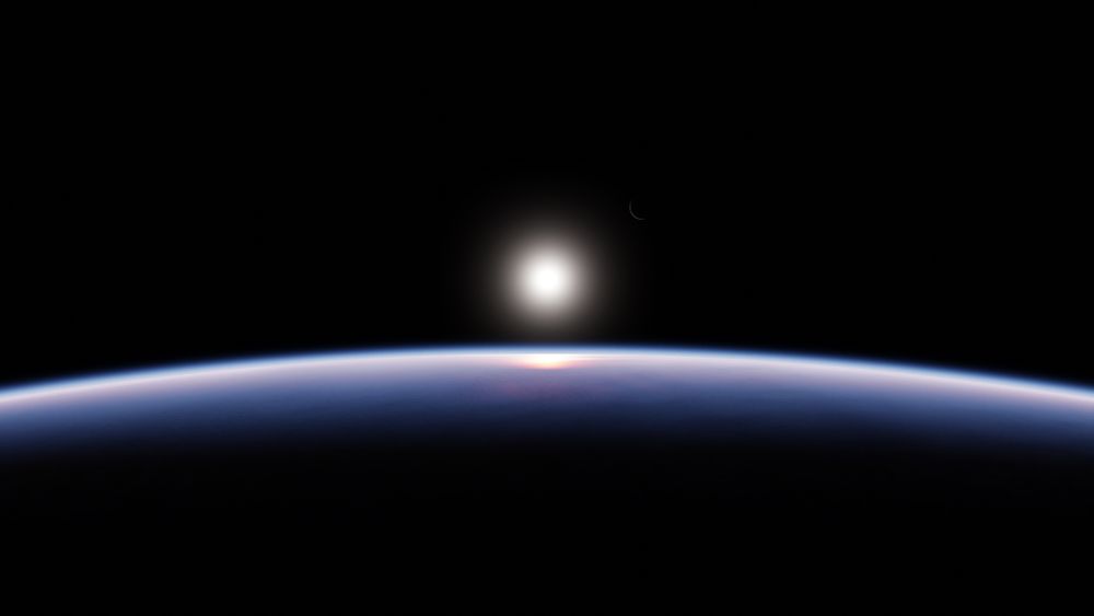 In this render, the sun rises over the Earth from a relatively high orbit point of view. The sunlight reflects reddish off the ocean and the terminator can be seen very clearly. Center right, the moon makes an appearance as a very thin crescent.