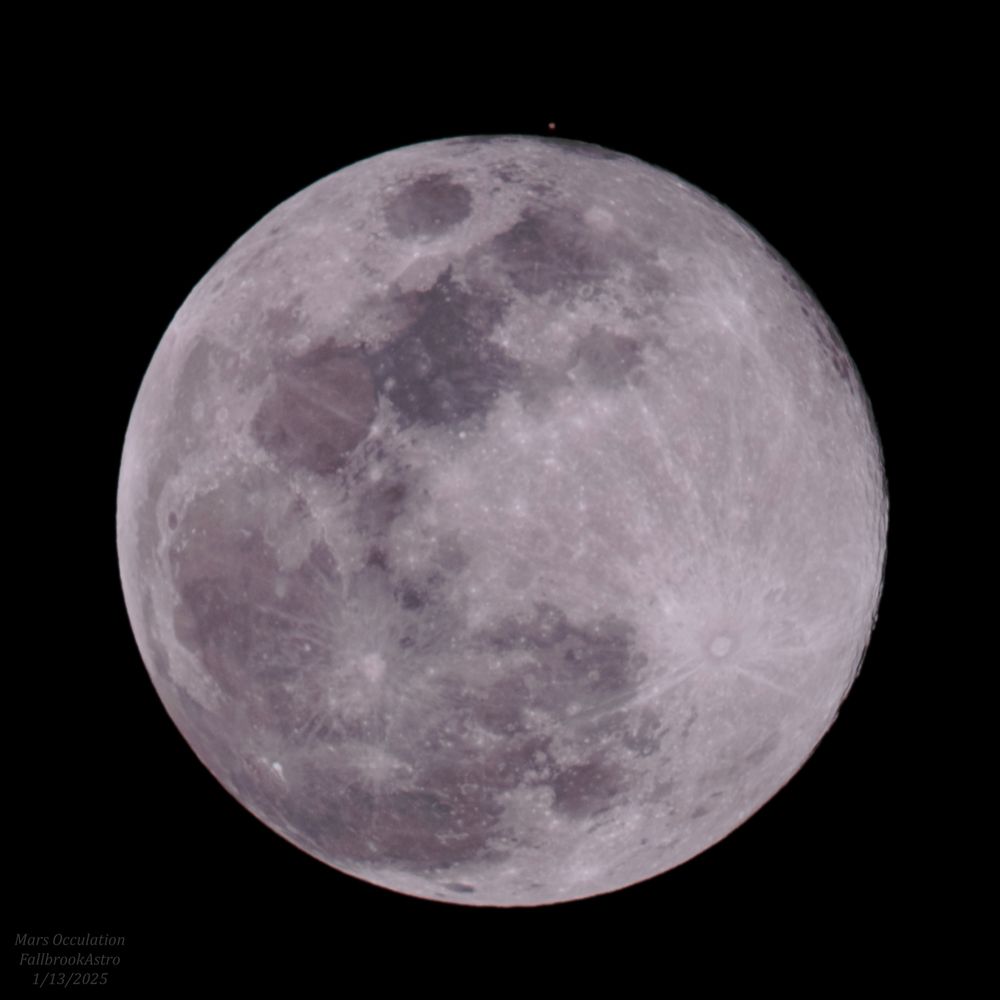 The Full Wolf Moon takes up most of the frame, with the exception of a small red dot just above it. This is the planet Mars, shortly after reappearing from behind the moon. This is known as an occultation. Zooming in, Mars has some vaguely resolved details such as darker regions of soil and polar ice caps. And yes, the moon is out of focus. Don’t mention it.