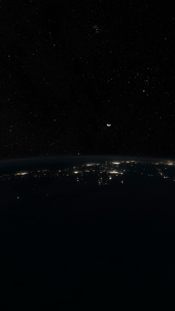 Render of Earth from space during nighttime. The moon glows in the distance above streetlights that gently glow through the atmosphere. Stars dot the sky all over.