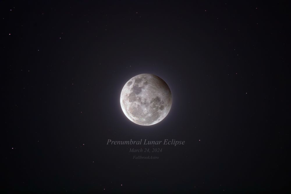 Prenumbral Lunar Eclipse, in HDR. The top right quarter of the full moon has a very prominent shadow over it with a slight red hue, reminiscent of sunsets on earth. Stars dot the background.