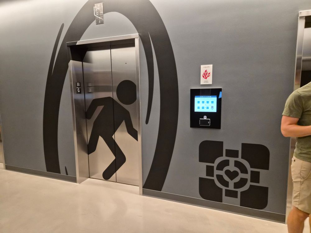 An elevator with Portal game graphics around it