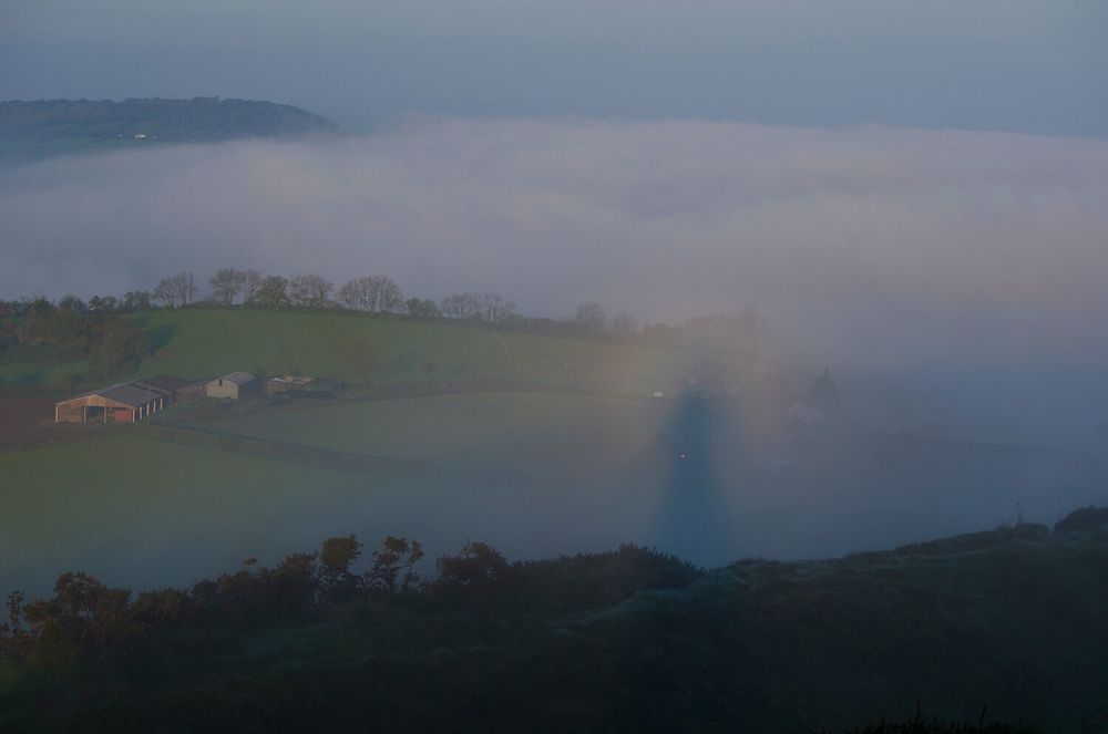 A Brocken spectre seen from a hill in Dorset, UK. There is a common misconception that Brocken spectres are only seen from mountains. This isn’t true. They can be at any elevation. Very lucky people sometimes see a version of this phenomenon known as Ulloa’s halo, where the shadow is surrounded by a bright area called the Heiligenschein, a glory and a fogbow. 

Photograph by Kerrie Ann Gardner. 