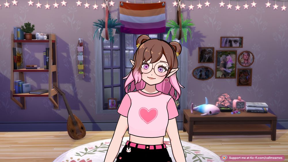 Ames' vtuber: a white humanoid model with shoulder length brown hair that turns pink in an ombre with double space buns held in place by small, pink heart clips. They have pointed elf ears and are wearing yellow star earrings. She has a pink crop top with a heart on it with black shorts. There is a bunny charm hanging off their belt loop. Behind her is a screenshot from the sims 4 of a bedroom with lilac walls. There is a bookshelf to one side beside them and a table with knicknacks on the other. There is a cluster of photoframes containing their tavs from baldur's gate 3 on the wall. Directly behind them is a bay window with a lesbian flag at the top of it.