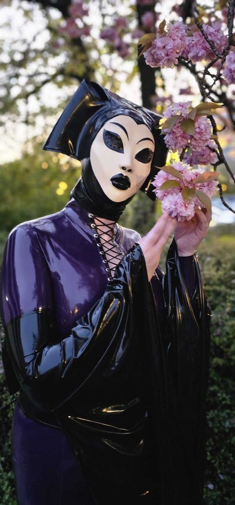 ToyDolly in a geisha and spider garden inspired latex outfit next to a glorious cherry blossom tree