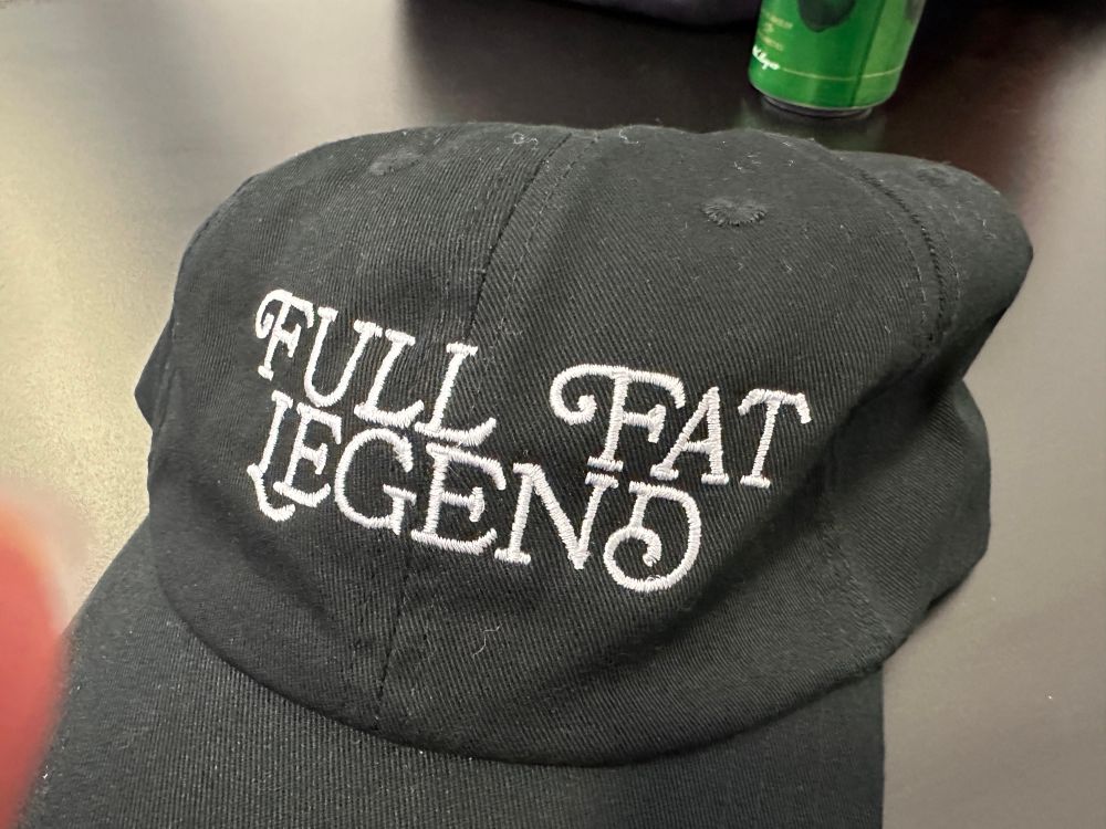 Baseball cap from Greg Davies merch selection. Black with “full fat legend“ embroidered on the front.