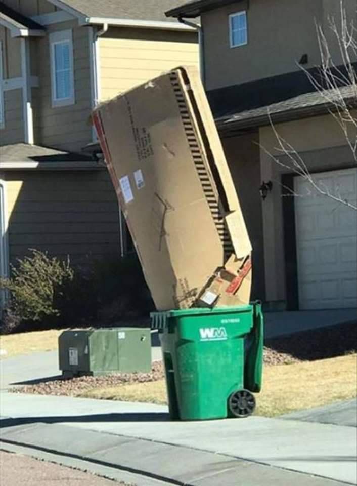 big ass cardboard box in a curbside garbage can
