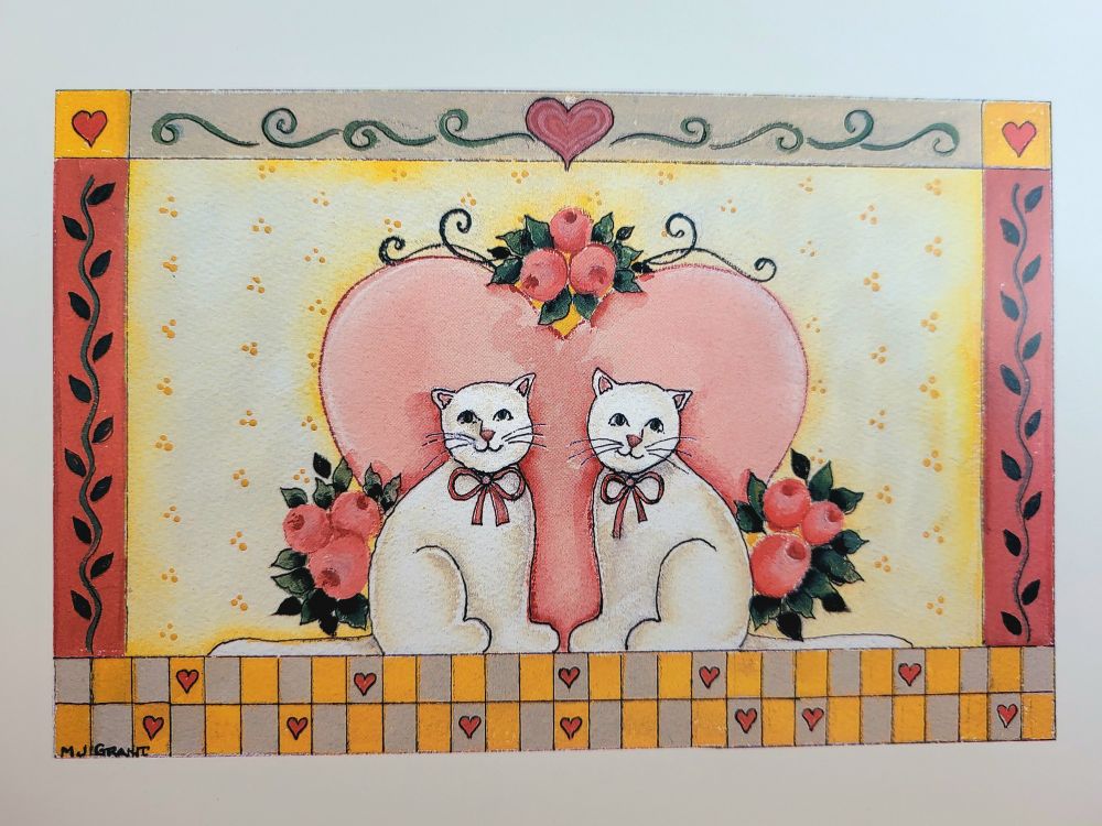 Triple by MJ Grant (Marina Grant). The artwork features two white cats with bows in front of a large cartoon heart. The heart is surrounded by 3 bouquets of round headed flowers. Mixed media of watercolor and ink, with possible acrylic for the more bold colors. I can't tell as the greeting card is only a print.