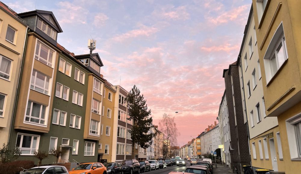 Photograph of colorful houses and sky with pink clouds
