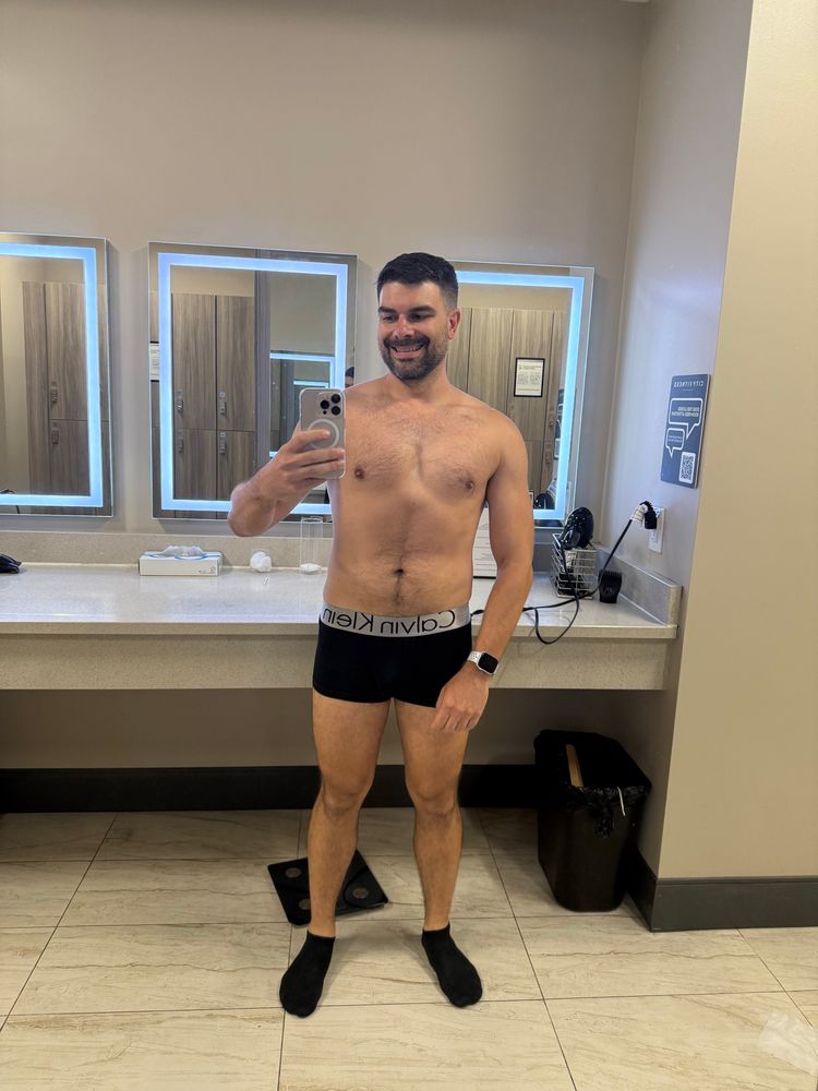 Man, taking Amy a selfie in the locker room, wearing a pair of underwear