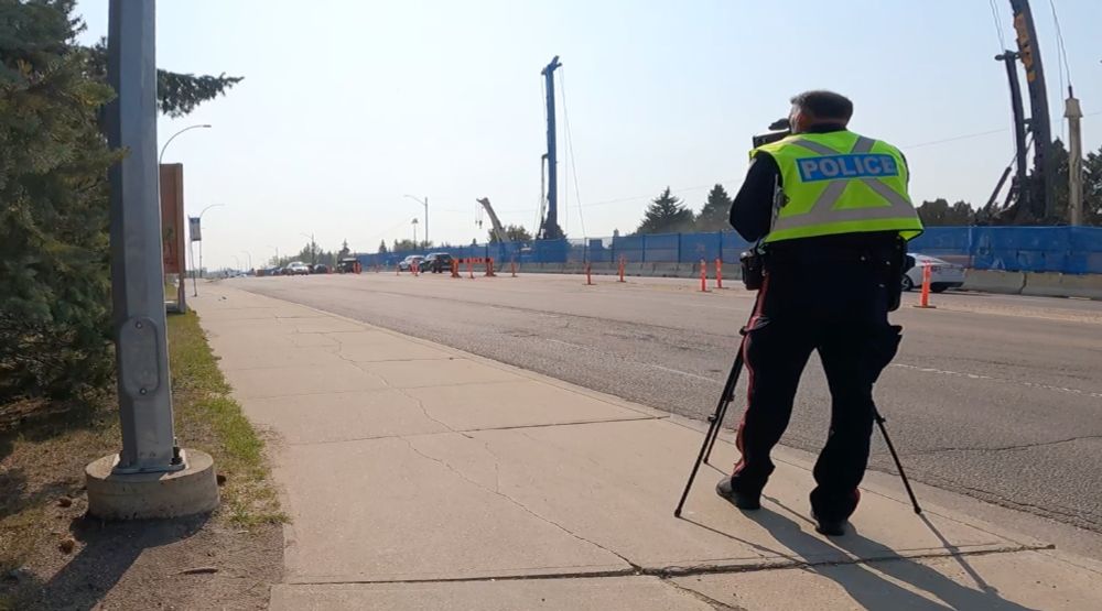 A police officer conducts speed enforcement in a construction zone.