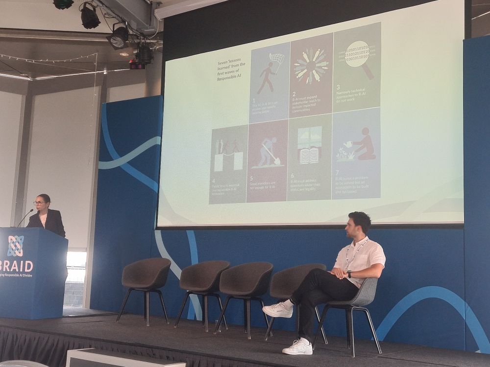 Shannon Vallor and Fabio Tollon on stage presenting their landscape study of responsible AI