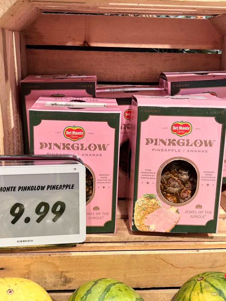 A grocery store shelf with Pinkglow pink pineapples. They’re $9.99. 