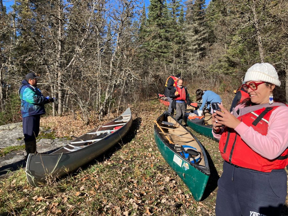 Canoes and educators from Sagkeeng First Nation.  Enjoying the noon sunlight where we put in below the Falls.